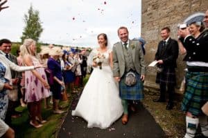 a couple walk through confetti on their wedding day
