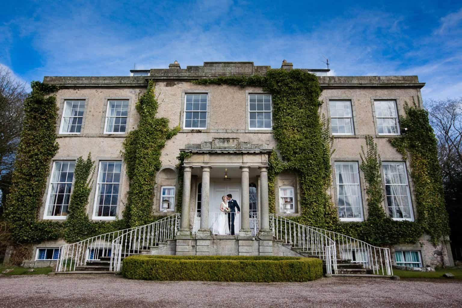 Cortes House wedding a couple pose for a photograph outside of cortes house