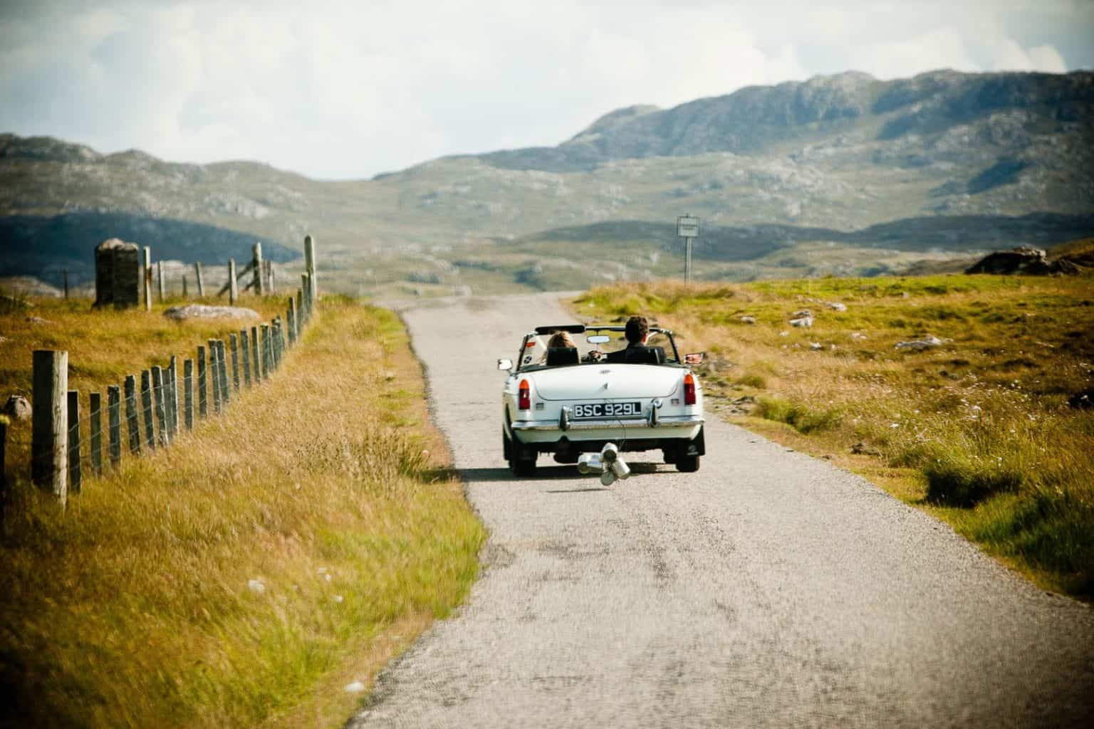 isle of lewis wedding a couple driving away together in a convertible car on their wedding day
