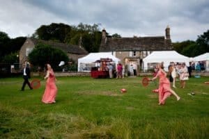 bridesmaids play badminto at a heathy lea weddings