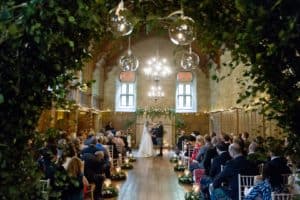 a bride and groom take their vows in a wedding ceremony at achnagairn castle