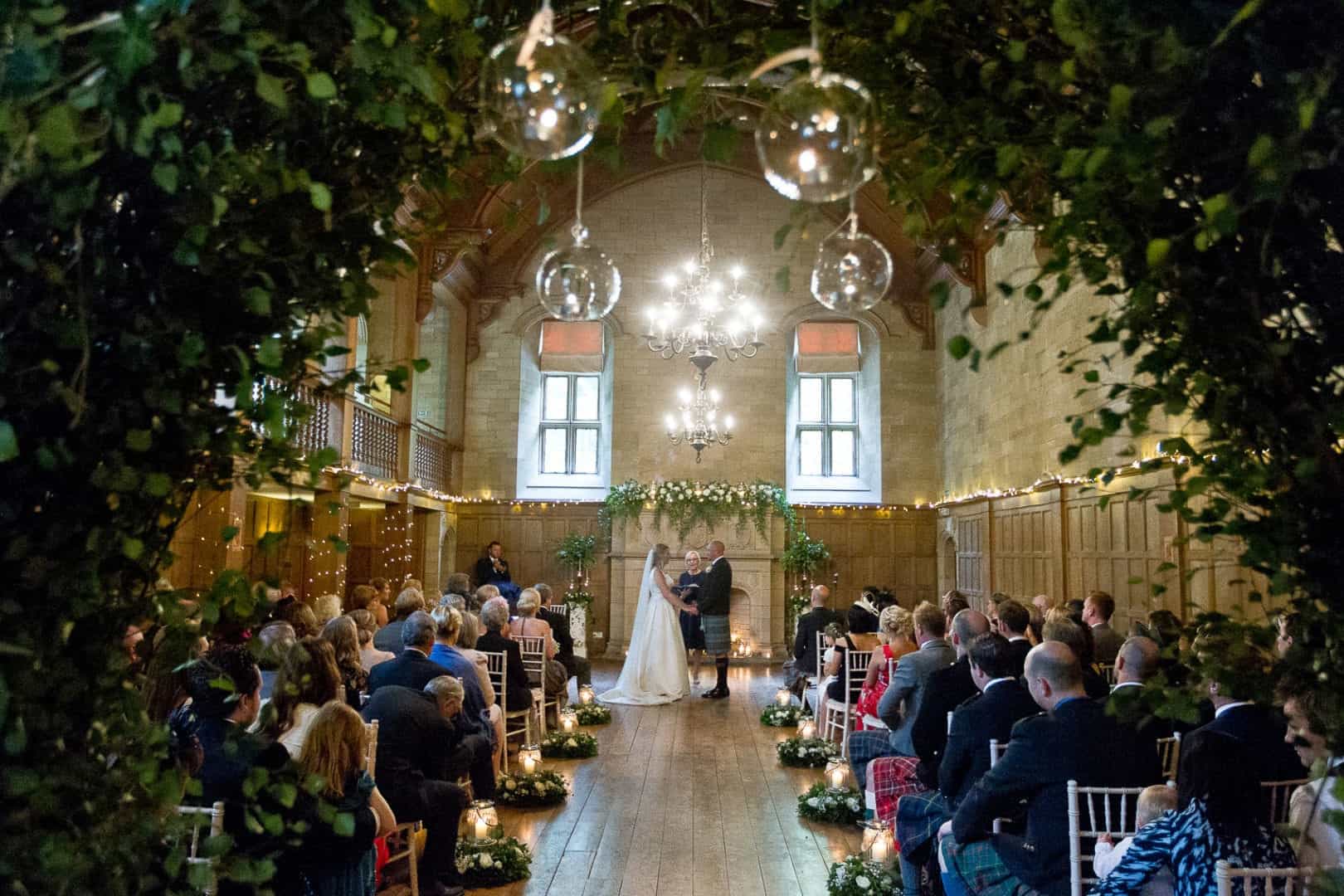 Illustrating an Achnagairn Castle wedding, a bride and groom take their vows in a wedding ceremony at achnagairn castle