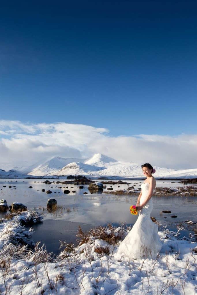 asian-bride-in-scotland an asian bride stands in the snow in scotland