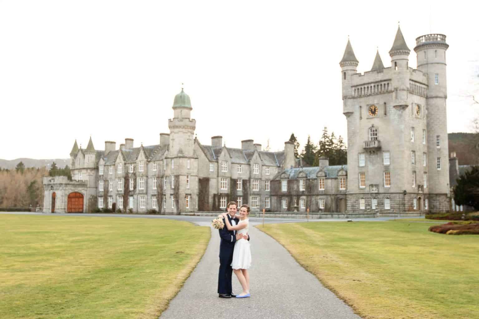 balmoral-castle-wedding-photograph a bride and groom standing outside balmoral castle in aberdeenshire