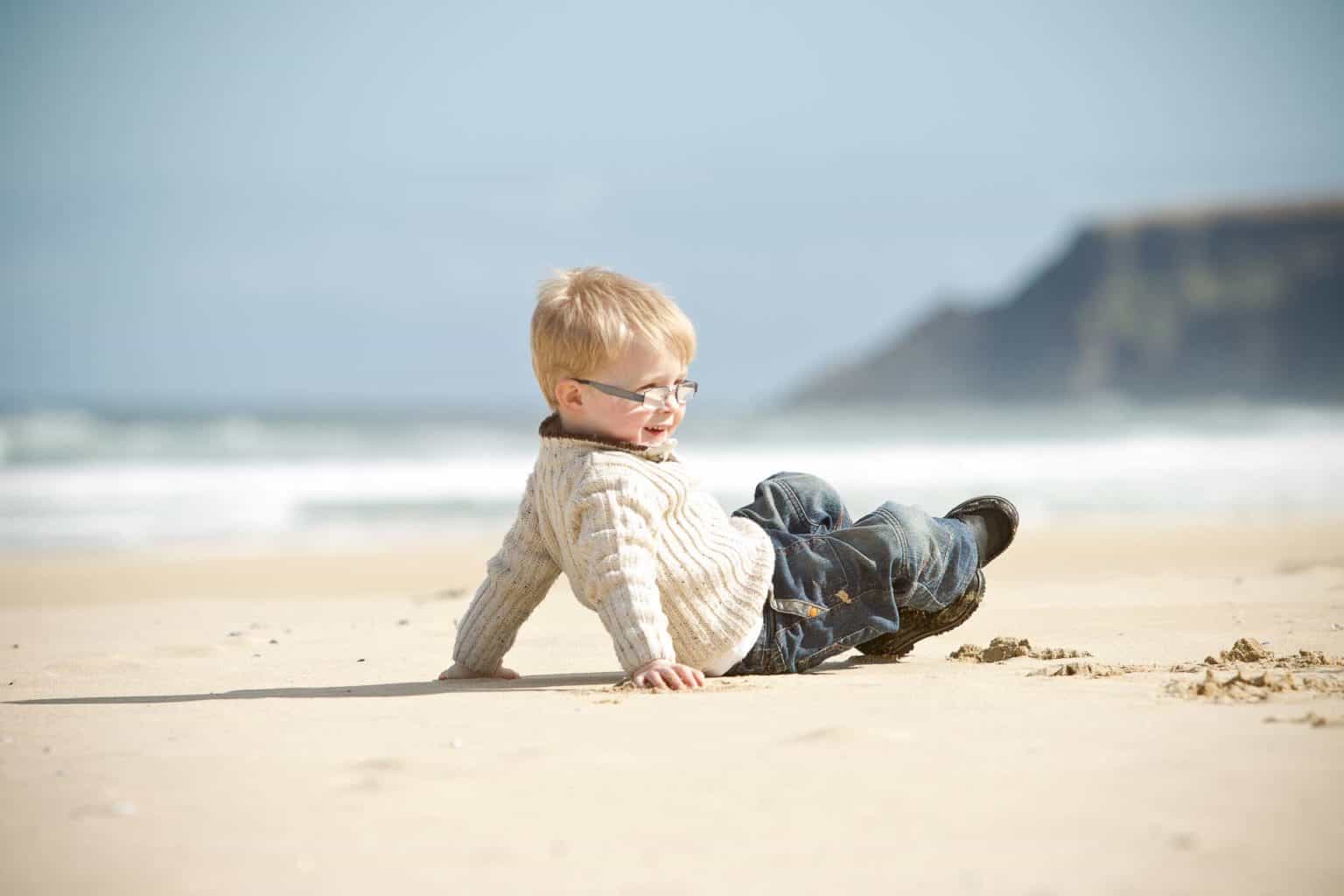 isle-of-lewis-family-photographer a young boy runs around in his family portrait session in lewis