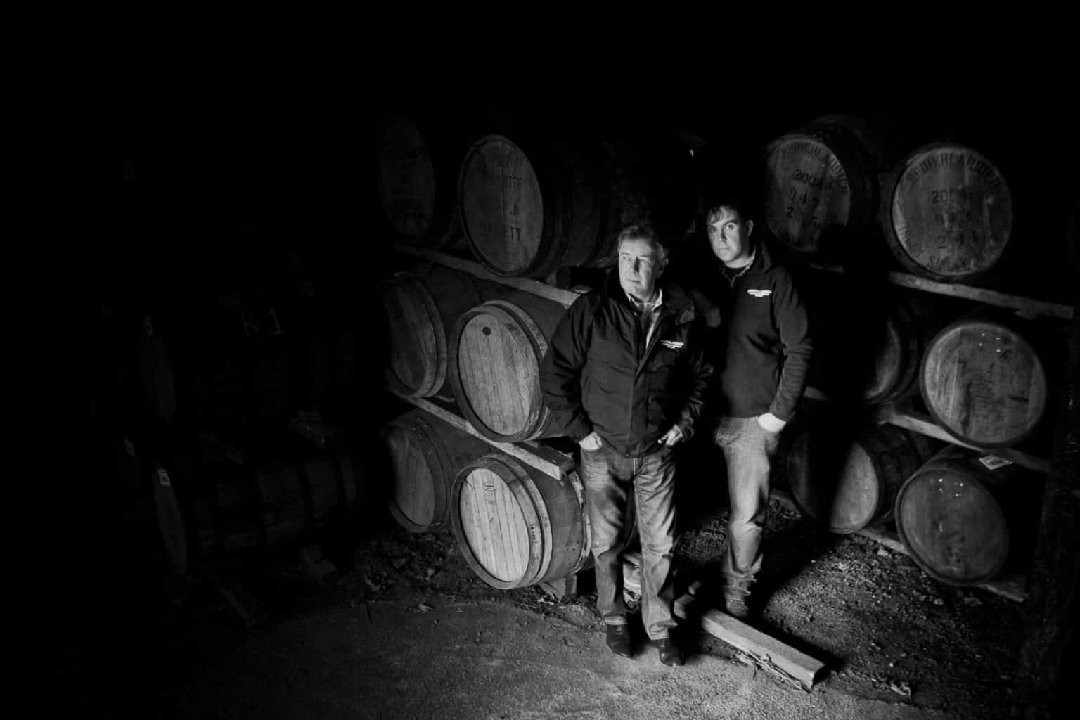 jim mcewand and allan logan in a whisky warehouse of bruichladdich distillery