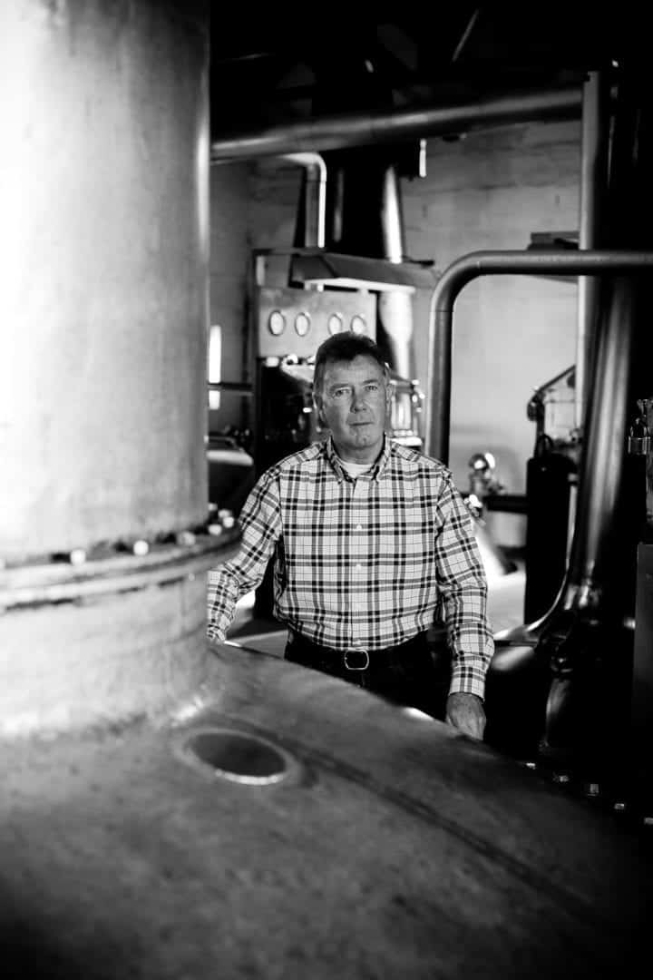 jim mcewan standing by ugly betty at islay distillery