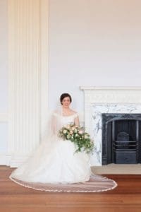 a bridal portrait of a bride sitting next the fireplace at lews castle in stornoway