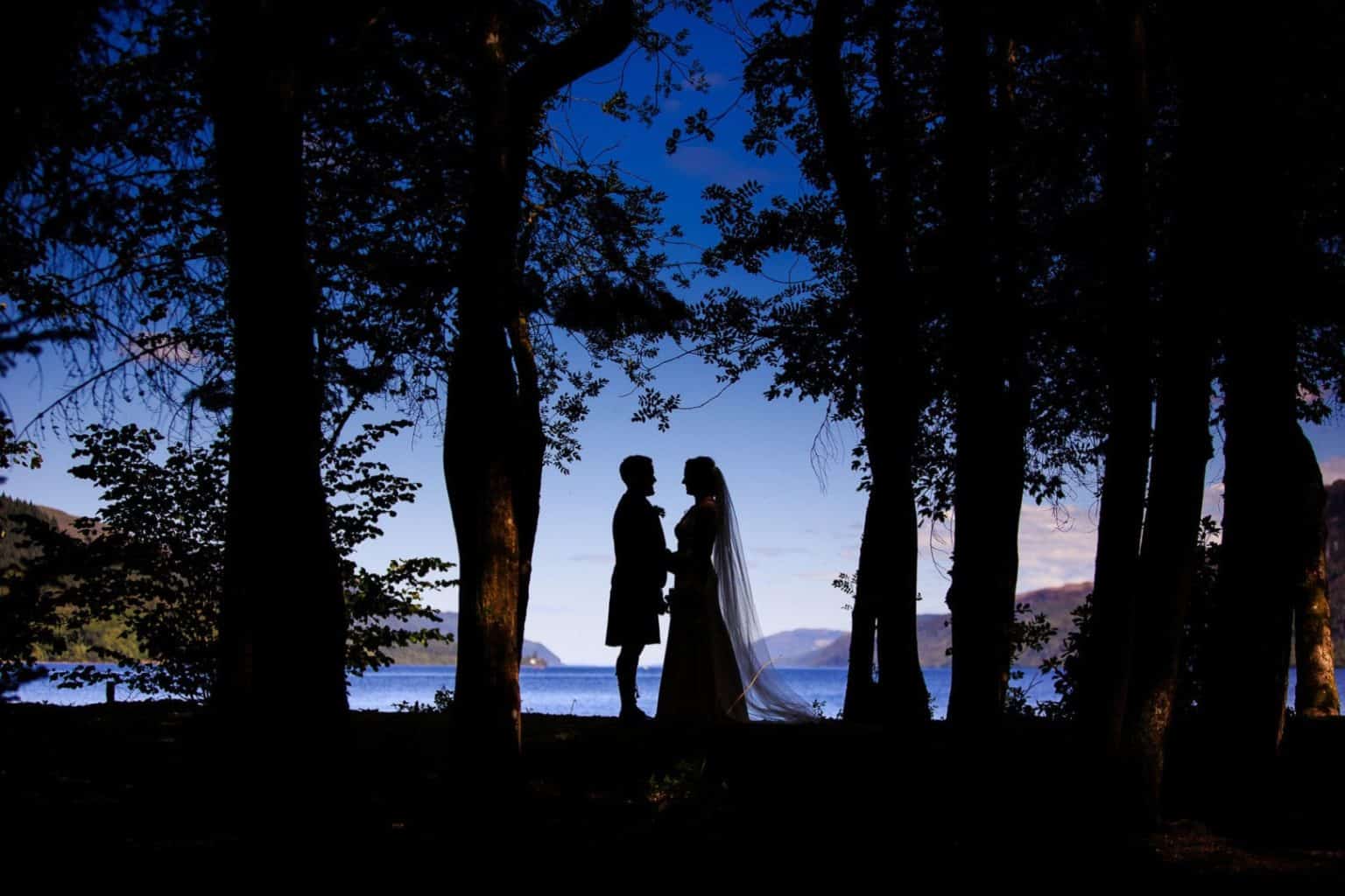 elope-to-the-isle-of-skye silhouette wedding photograph of a bride and groom on their scottish elopement at loch ness