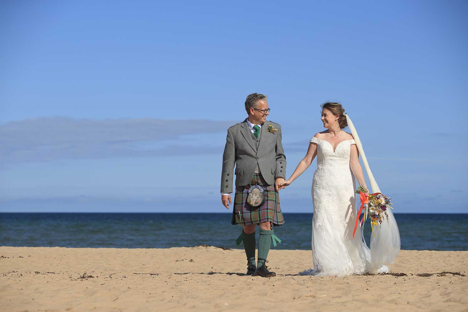 Dornoch beach wedding bridge and groom